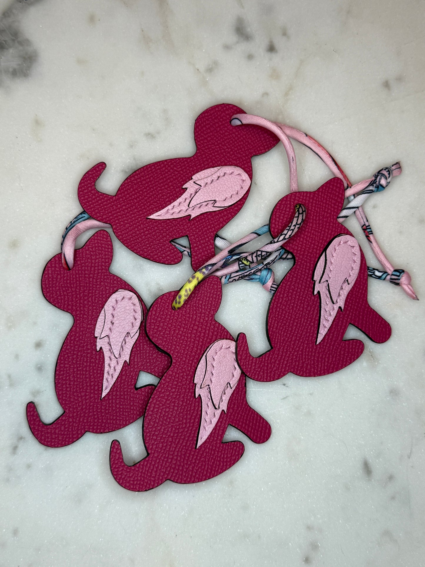 Dog bag charms pink calfskin and goat skin.